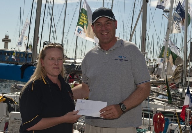 Angela Matthews, Secretary, St Helens Marine Rescue, receives cheque from CYCA Commodore Matt Allen, Chairman of CYCA